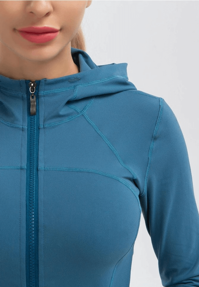 Women's blue long-sleeve quick-drying sports shirt with hood for yoga, showing zipper detail and full sleeves.